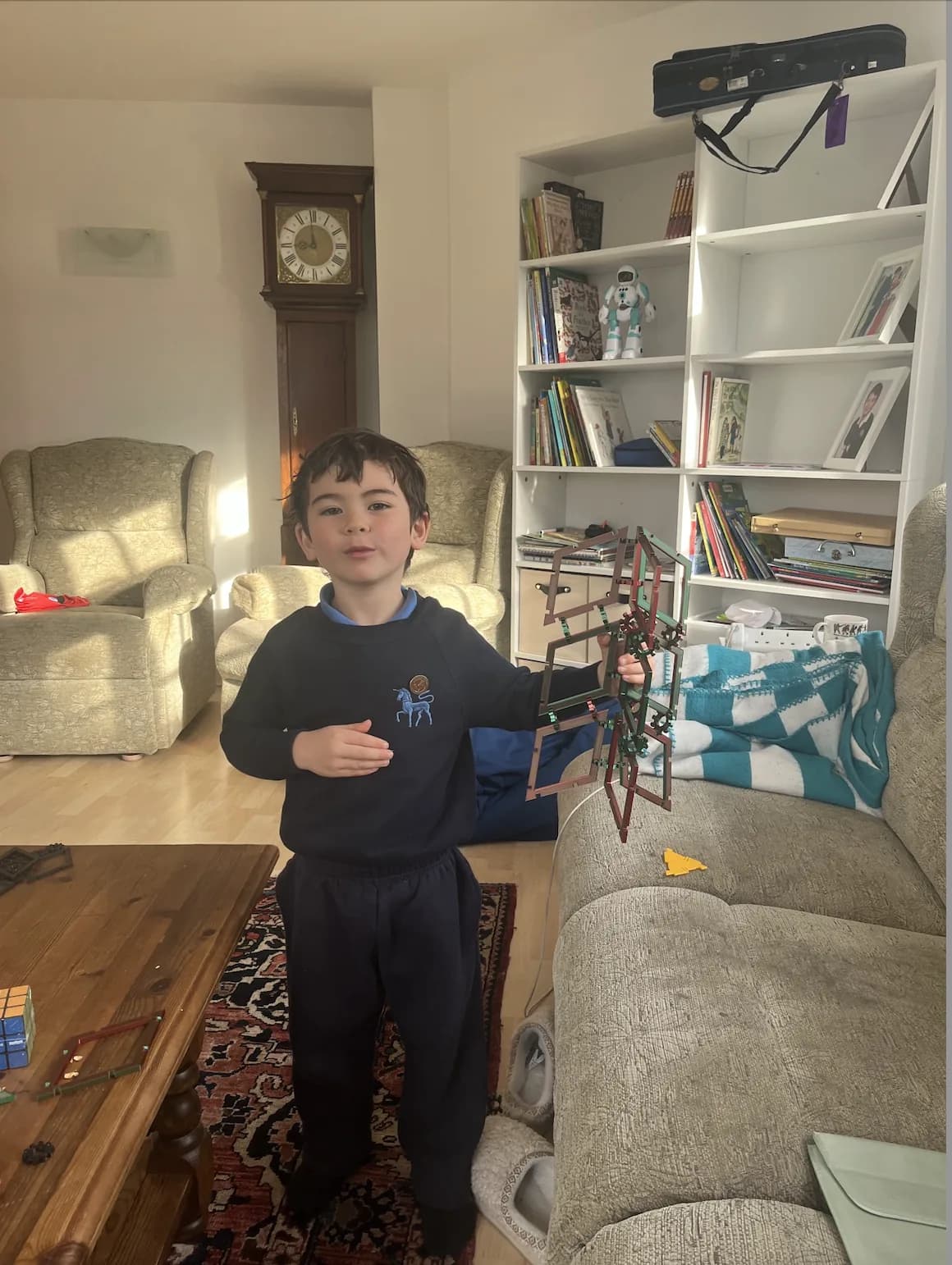 A young builder proudly showing a Golden Rhomboi creation